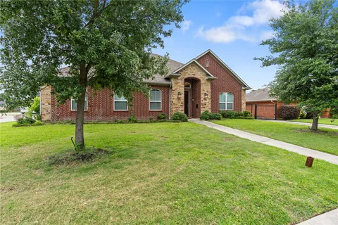 a front view of house with yard and green space