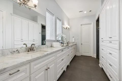 a spacious bathroom with double sink and a mirror