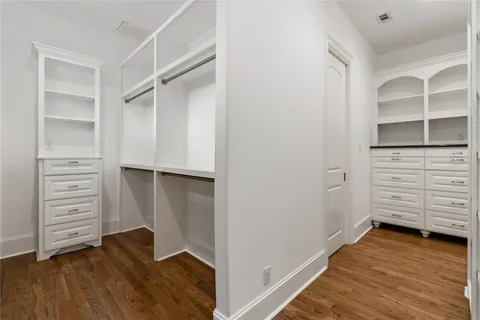 a view of walk in closet with empty racks