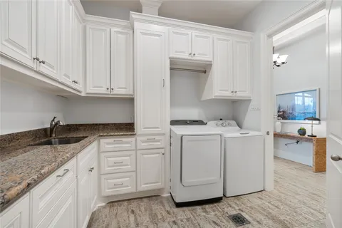 a kitchen with cabinets appliances a sink and a counter space