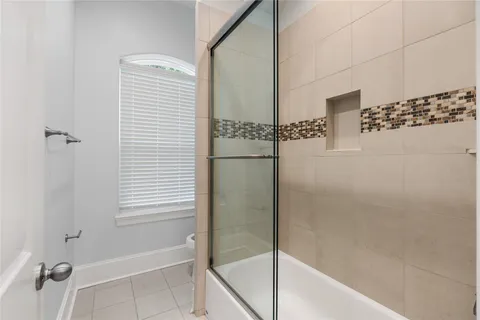 a bathroom with a bathtub and shower