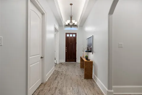 a view of a hallway view with wooden floor and staircase