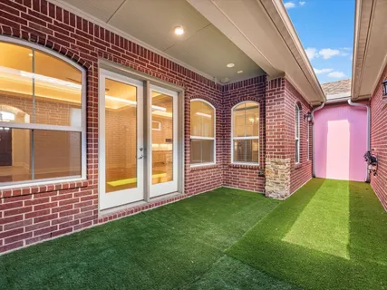 a view of an house with backyard and porch