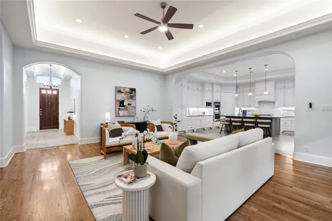 a living room with furniture and kitchen view