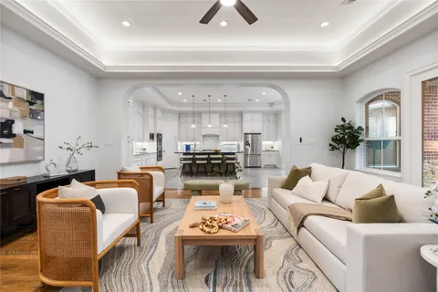 a living room with furniture a rug and a chandelier