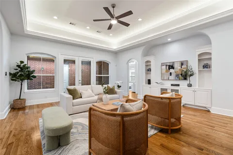 a living room with furniture and wooden floor