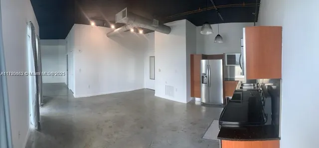 a view of a hallway with a kitchen