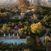 an aerial view of a house with a yard and lake view