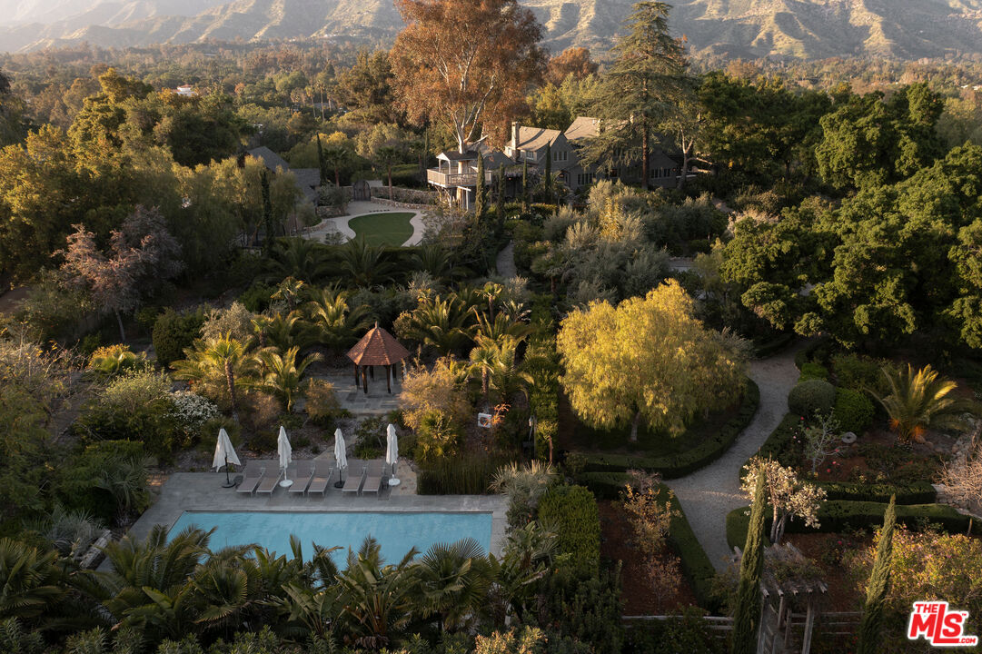 an aerial view of a house with a yard and lake view