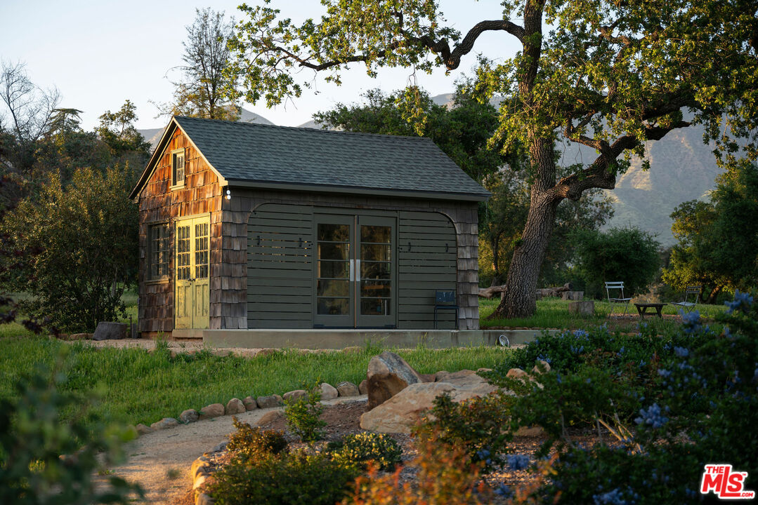 San Antonio Street Ojai, CA 93023 - Photo 53 of 73 a backyard of a house with plants and large tree