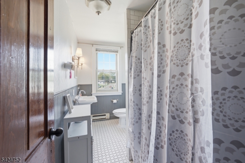 1401 Mt Holly Road Burlington, NJ 08016 - Photo 13 of 23 a bathroom with a granite countertop shower a toilet and a shower curtain