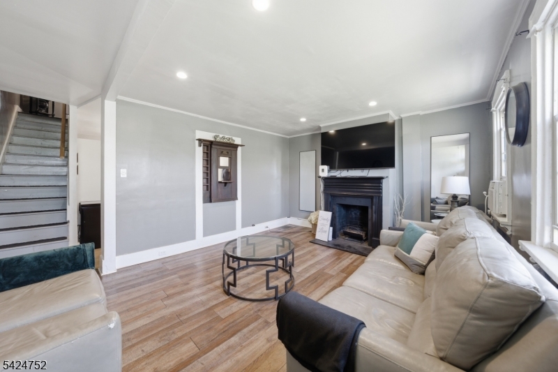 1401 Mt Holly Road Burlington, NJ 08016 - Photo 3 of 23 a living room with furniture a fireplace and a flat screen tv