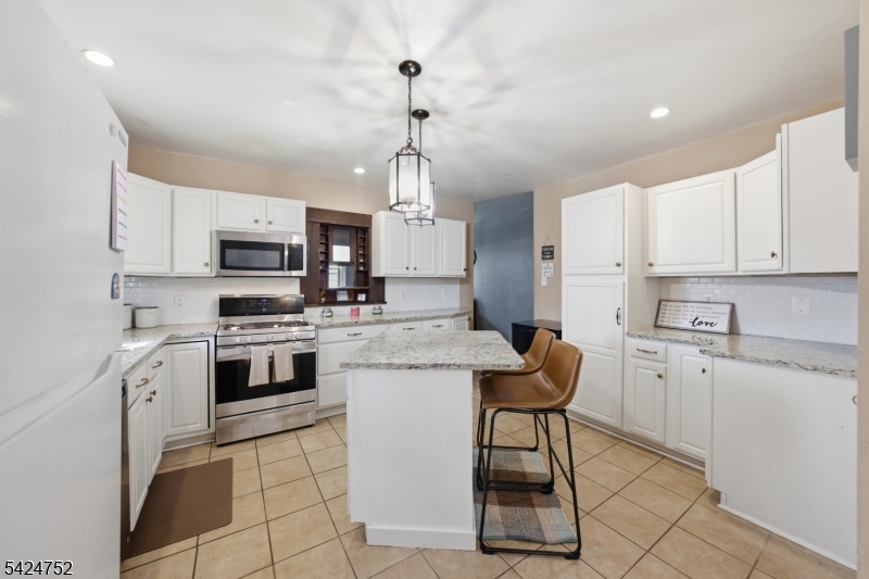 1401 Mt Holly Road Burlington, NJ 08016 - Photo 4 of 23 a kitchen with white cabinets stainless steel appliances and a counter top space
