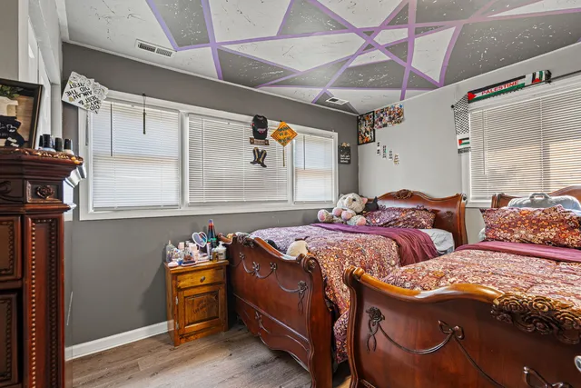 a bed sitting in a bedroom next to a window