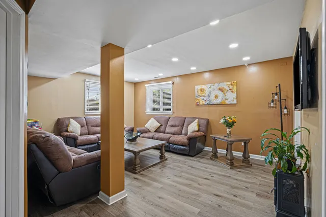 a living room with furniture wooden floor and a flat screen tv