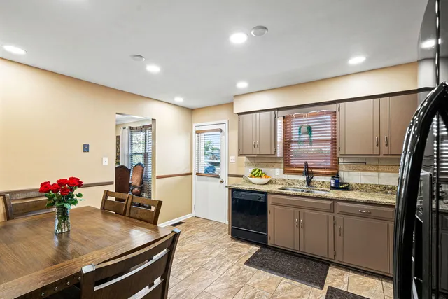 a kitchen with sink refrigerator and window
