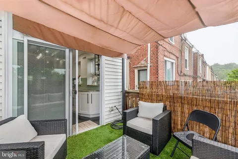 a view of a patio with couches table and chairs and potted plants