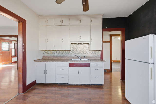869 West Center Street Provo, UT 84601 - Photo 14 of 32 Kitchen featuring freestanding refrigerator, ceiling fan, white cabinetry, light countertops, and dark wood finished floors