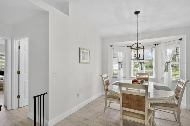 a dining room with furniture and window