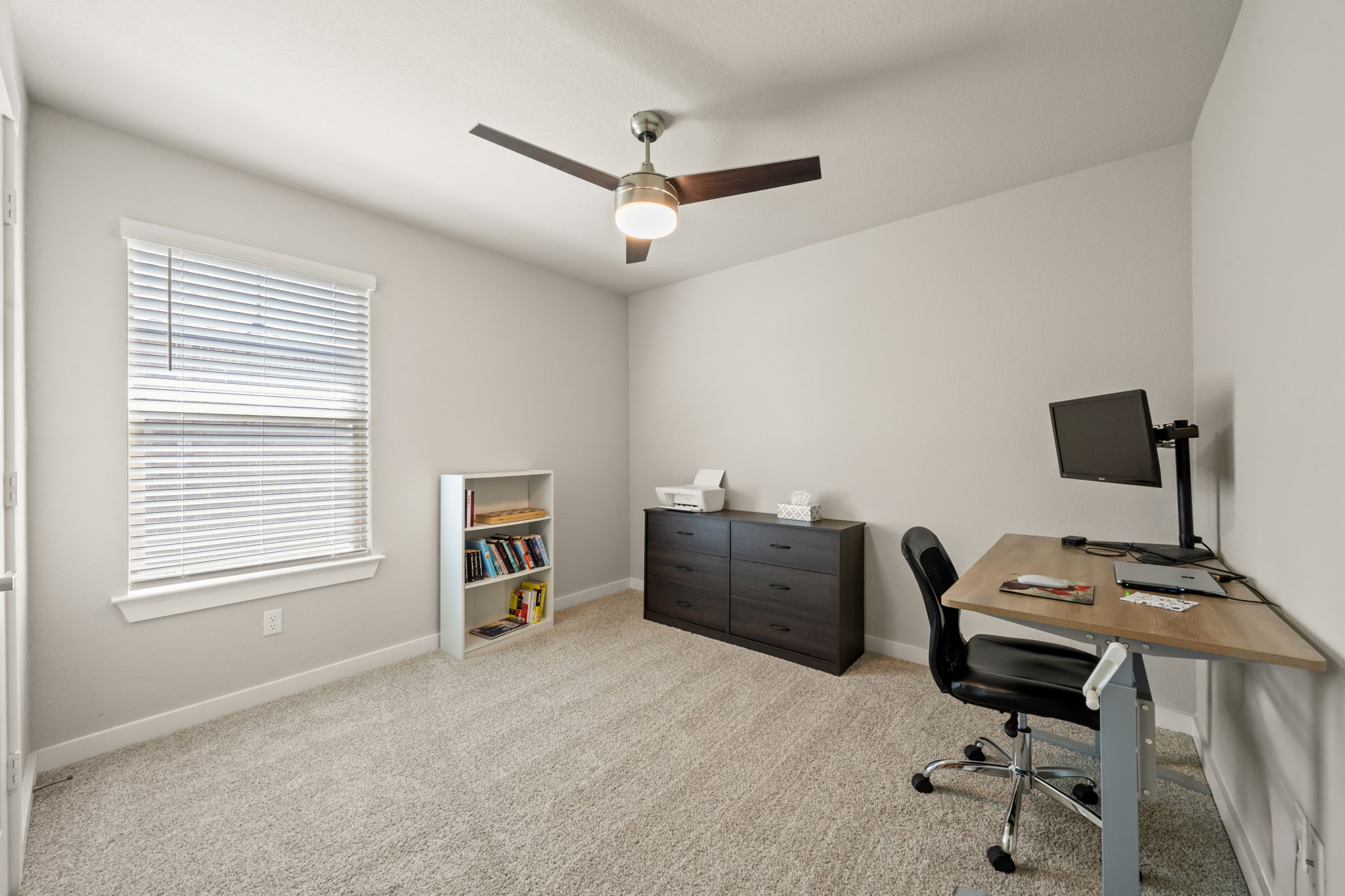1117 Tipton Street Georgetown, TX 78633 - Photo 30 of 40 Neutral-toned interior room featuring carpet flooring, a window with blinds, and a ceiling fan with integrated lighting