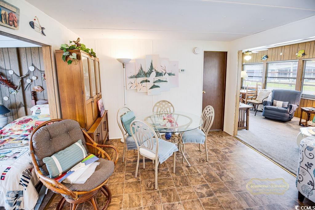 298 Flamingo Surfside Beach, SC 29575 - Photo 15 of 27 Dining space with wooden walls and stone finish flooring