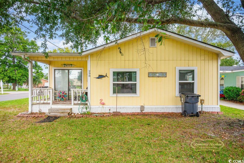 298 Flamingo Surfside Beach, SC 29575 - Photo 21 of 27 View of front of home featuring a front lawn and a deck