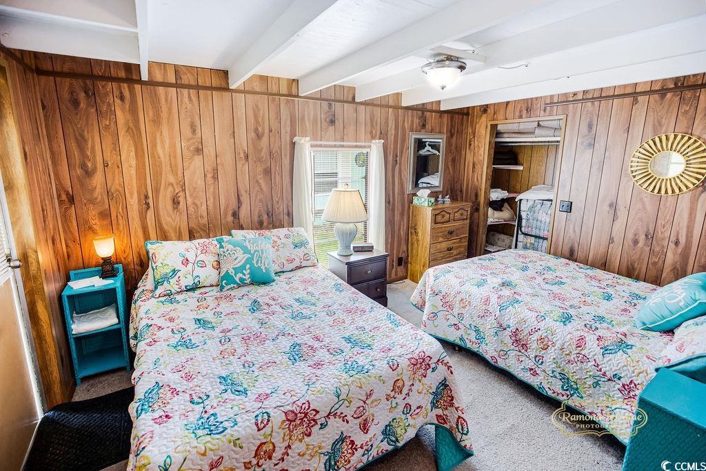298 Flamingo Surfside Beach, SC 29575 - Photo 7 of 27 Bedroom featuring beamed ceiling, wooden walls, carpet, and a closet