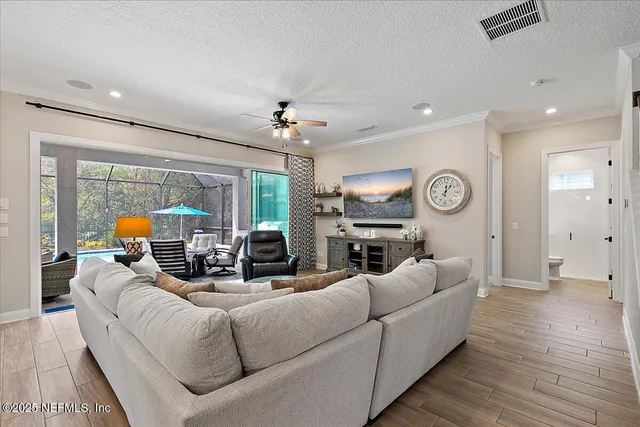 a bedroom with furniture and a large window