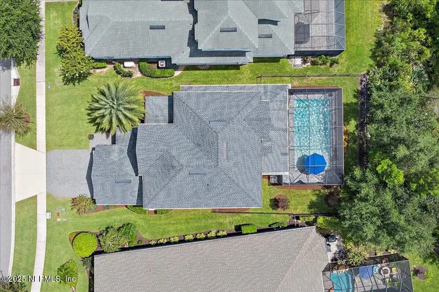 a kitchen with stainless steel appliances granite countertop a sink a stove a refrigerator and white cabinets