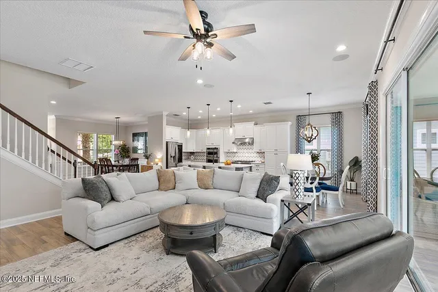 a living room with furniture large window and flat screen tv