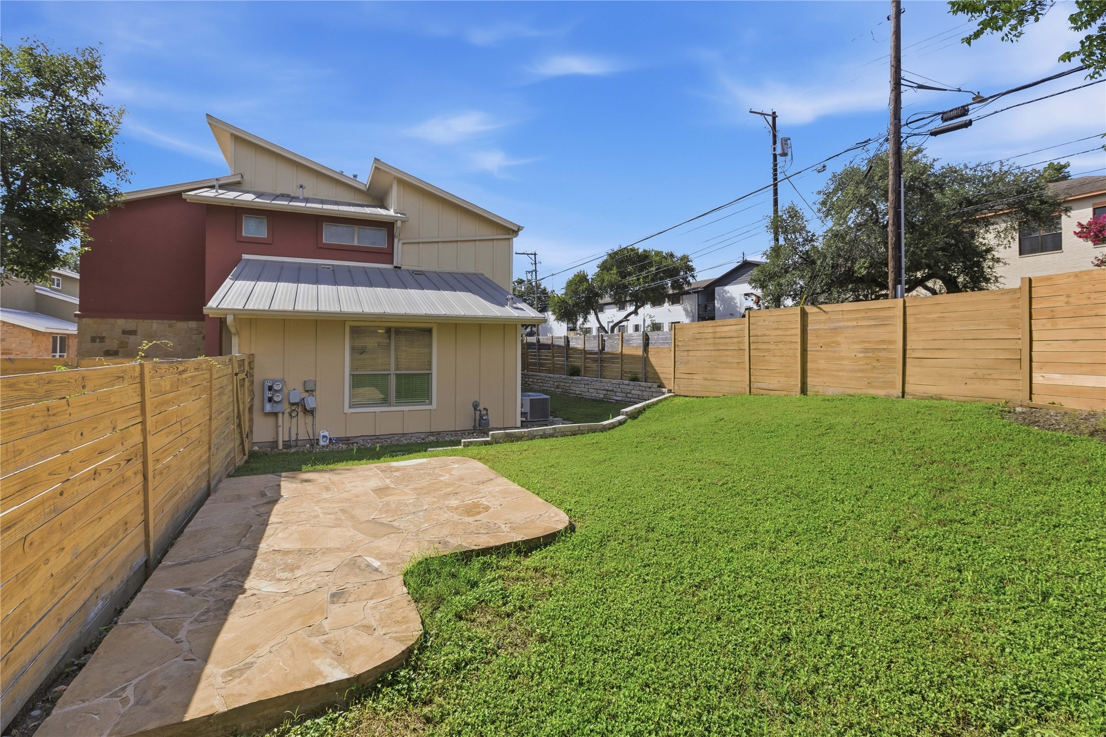 4124 Valley View Road, Unit 4A & 4B Austin, TX 78704 - Photo 14 of 40 A spacious yard with fresh green grass and a natural stone patio invites outdoor enjoyment.
