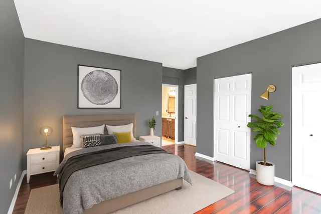 a bedroom with a bed and a potted plant