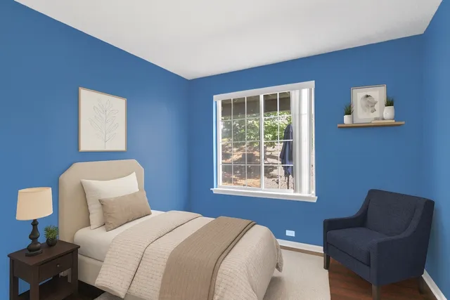 a bedroom with a bed and a chair