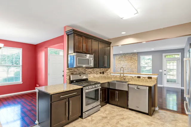 a kitchen with a stove sink and cabinets
