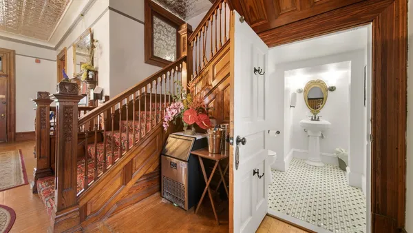 a view of hallway with wooden floor and stairs