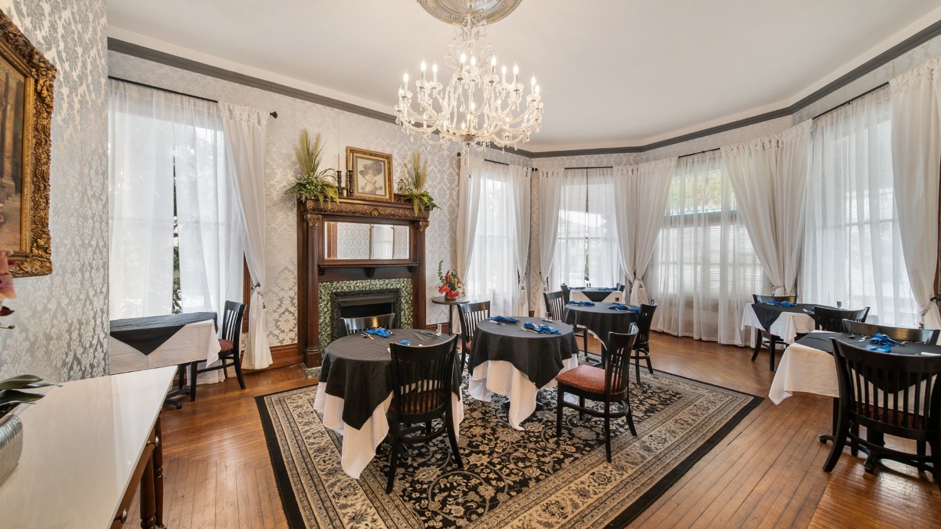 511 17th Street Galveston, TX 77550 - Photo 18 of 30 a living room with fireplace furniture and a chandelier