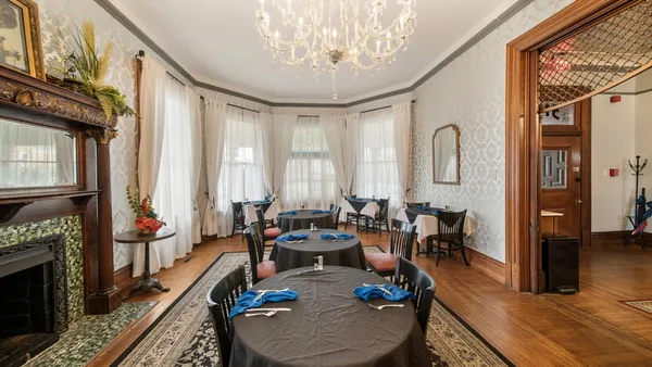 a living room with furniture fireplace and a window