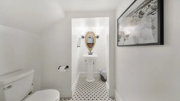 a bathroom with a toilet and a view of bathroom