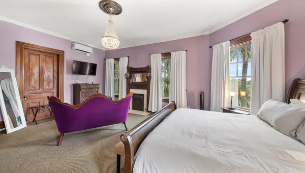 a bedroom with furniture and a flat screen tv