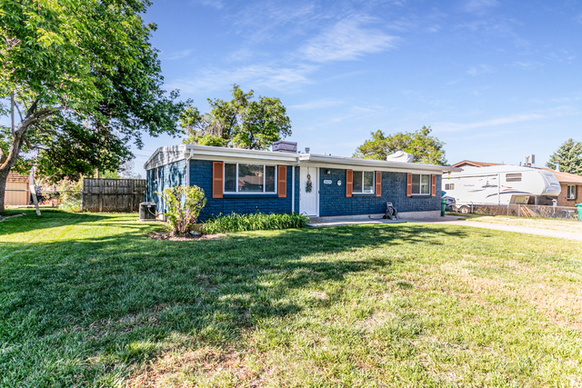 1619 Davis Drive Layton, UT 84041 - Photo 1 of 27 Blue brick facade with white trim, featuring a white entry door and decorative wooden shutters