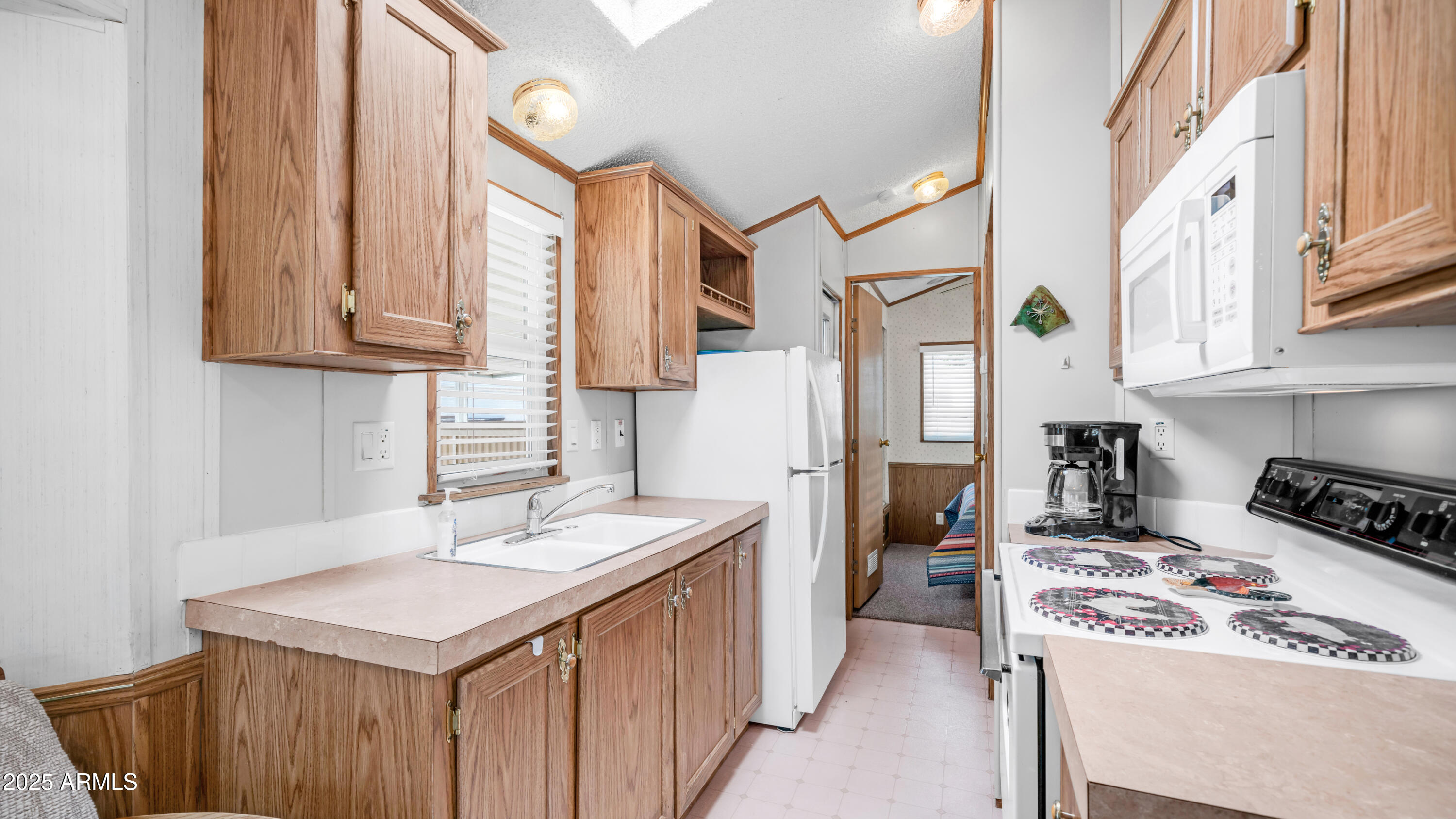 579 Jasper Drive, Unit 579 Apache Junction, AZ 85119 - Photo 12 of 56 a kitchen with stainless steel appliances granite countertop a sink stove and refrigerator
