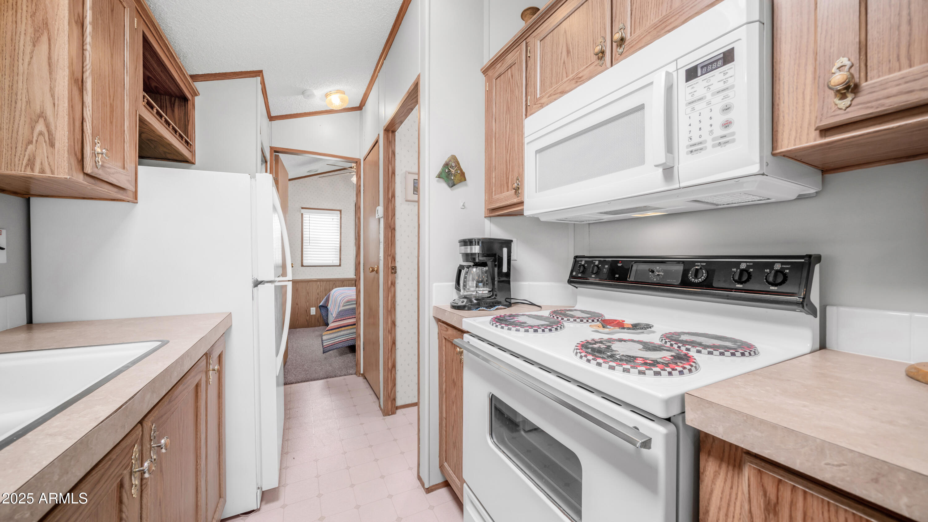 579 Jasper Drive, Unit 579 Apache Junction, AZ 85119 - Photo 13 of 56 a kitchen with a stove and a refrigerator