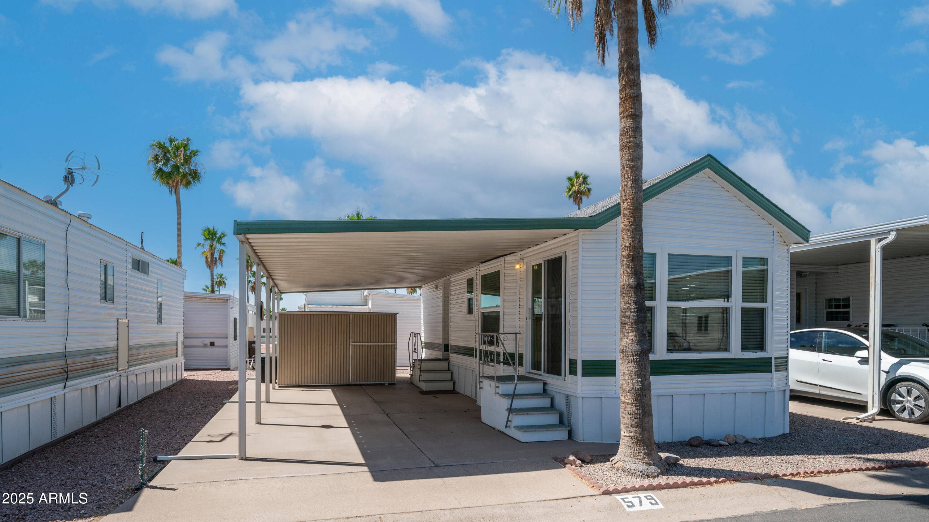 579 Jasper Drive, Unit 579 Apache Junction, AZ 85119 - Photo 4 of 56 a front view of a house with a garden