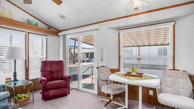 a living room with furniture ceiling fan and a window