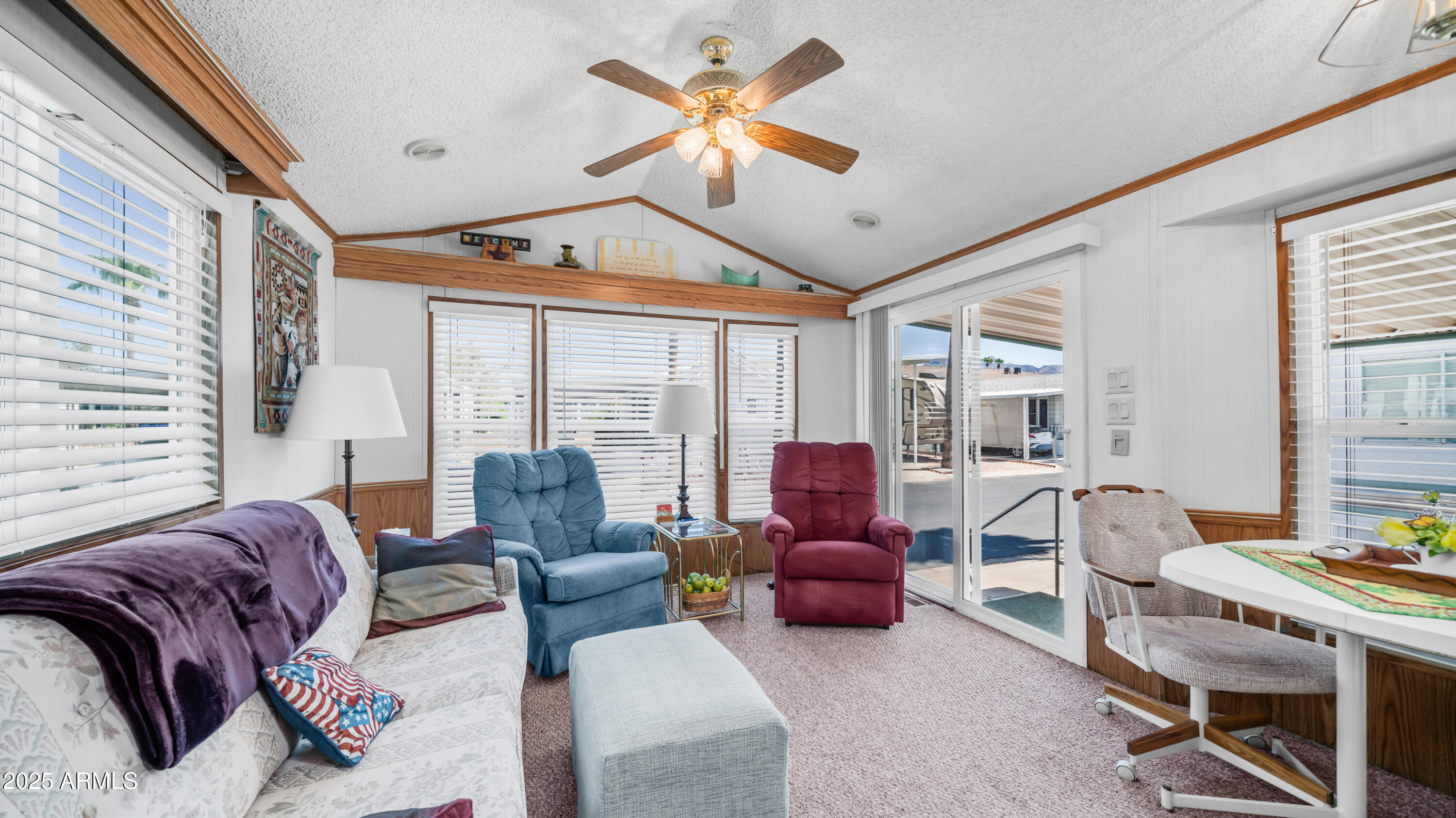 579 Jasper Drive, Unit 579 Apache Junction, AZ 85119 - Photo 9 of 56 a living room with furniture ceiling fan and a window