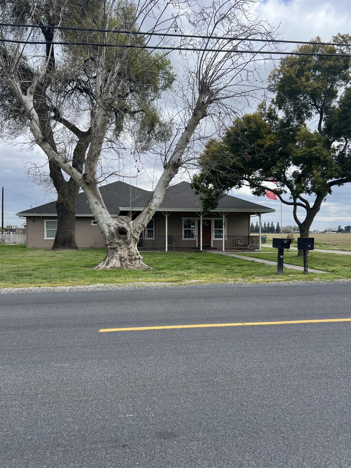 742 Mitchell Road Turlock, CA 95380 - Photo 1 of 1 a yellow house with trees in front of it