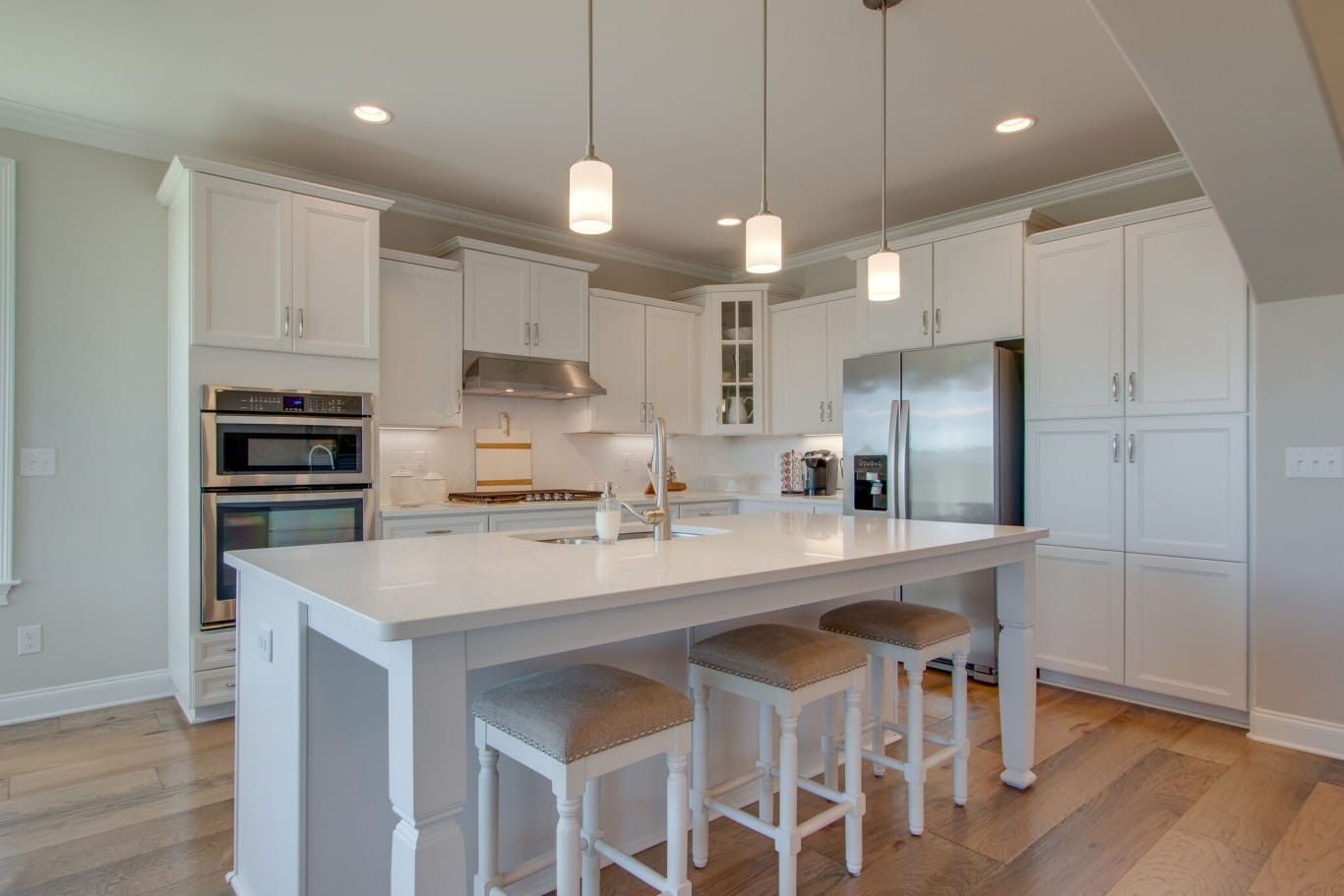 3584 Robbins Nest Road Thompson's Station, TN 37179 - Photo 17 of 43 a kitchen with stainless steel appliances kitchen island granite countertop a sink a stove a refrigerator and island with wooden floor