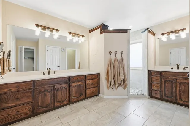 a spacious bathroom with a granite countertop sink mirror and a bathtub