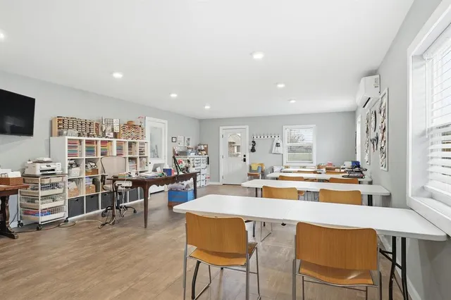 a view of a dining room with furniture and a flat screen tv