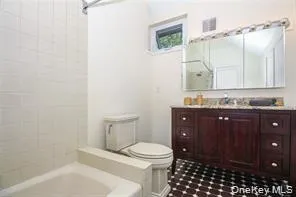 a bathroom with a granite countertop sink a toilet and a mirror